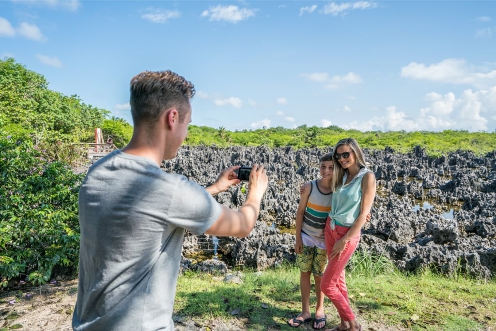 Family taking a photo from Hell Limestone Formations, Grand Cayman