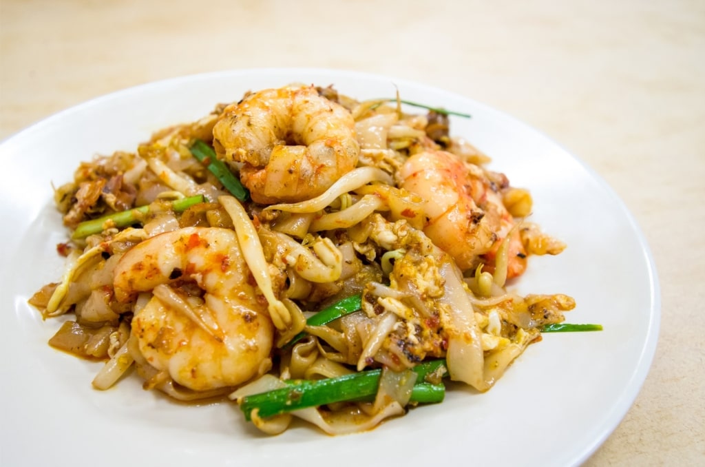 Plate of char kway teow with shrimp on top