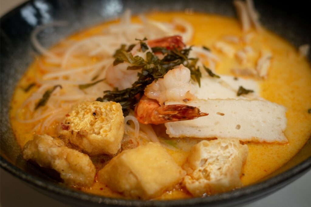 Laksa topped with tofu and chicken