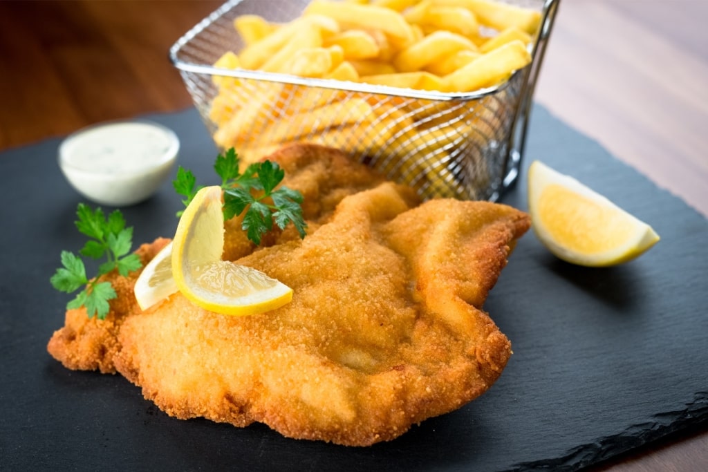 Wiener Schnitzel on a plate with fries on the side