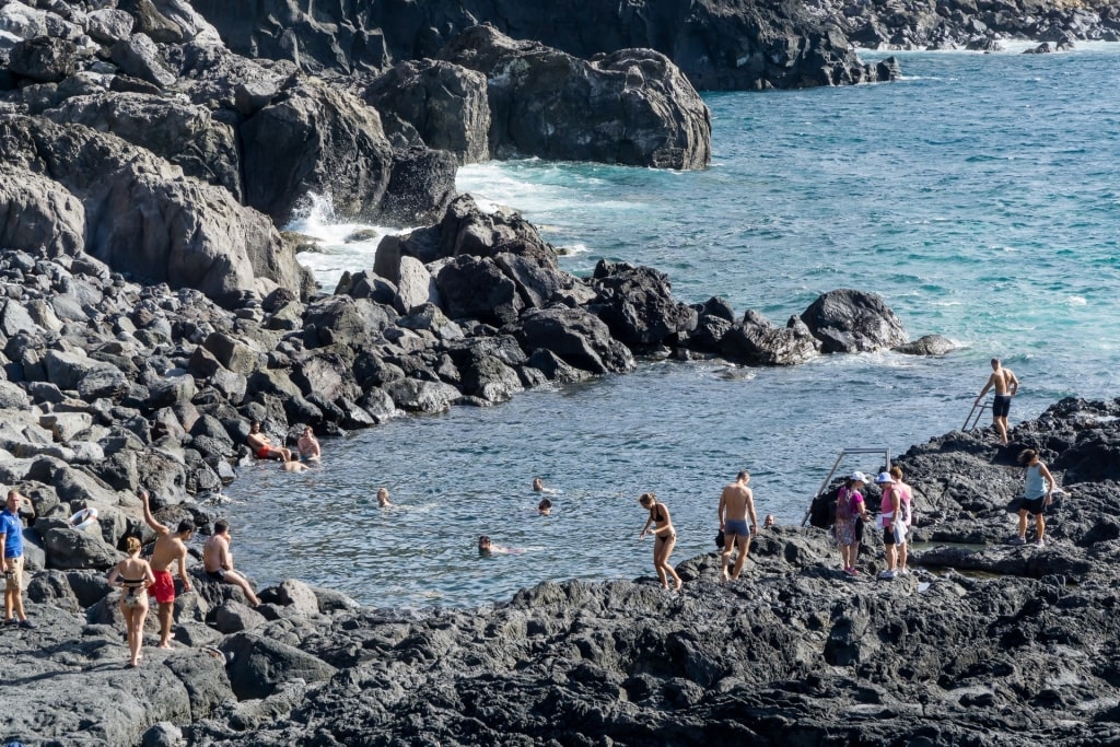 People swimming in Ponta da Ferraria