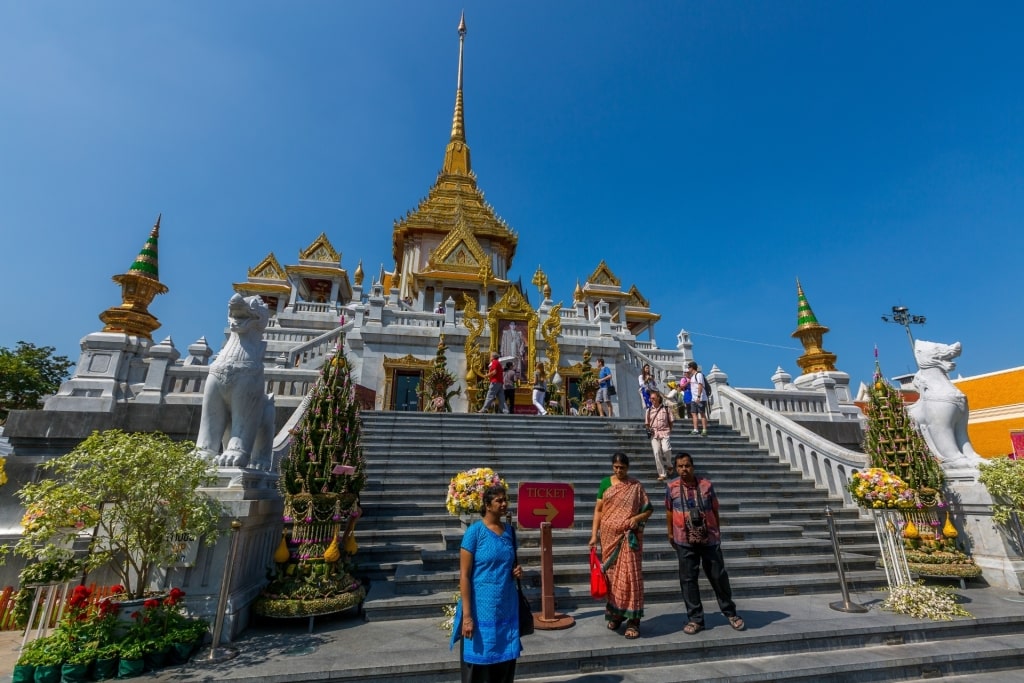 People exploring Wat Traimit, Bangkok