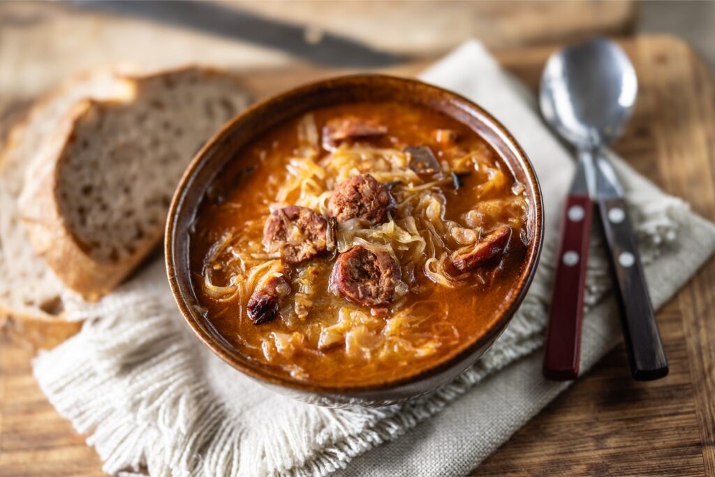 Bowl of hearty kapustnica with bread on the side
