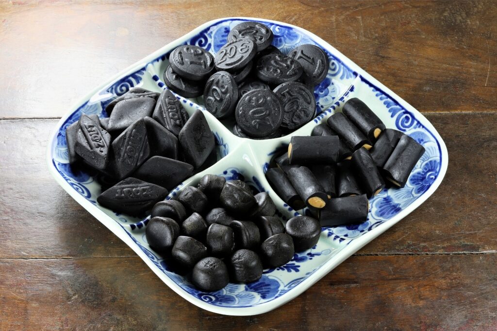 Dutch licorice drops on Delftware souvenir plate in Amsterdam