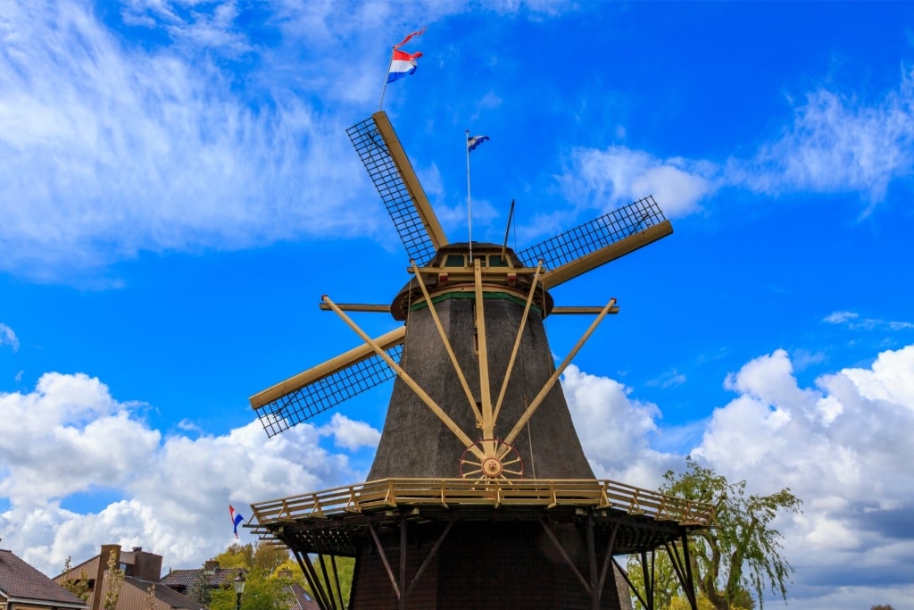 Molen De Vriendschap windmill in Amsterdam under blue sky