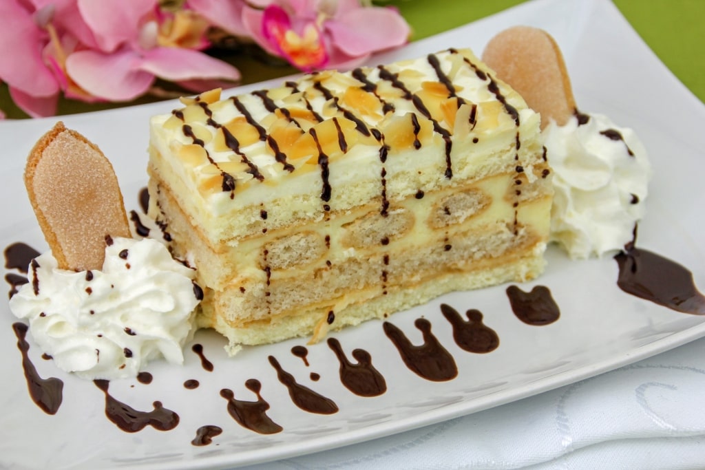 Slice of Malakofftorte dessert with layered cream and sponge