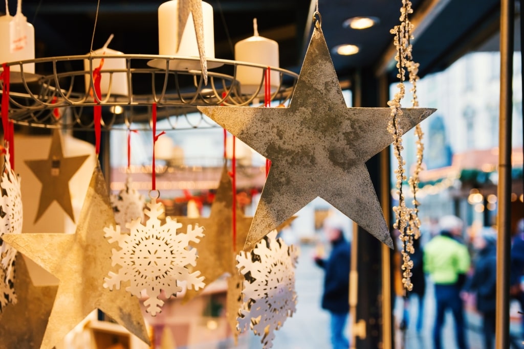 Artisan star-shaped decorations made of wood and metal displayed at holiday market