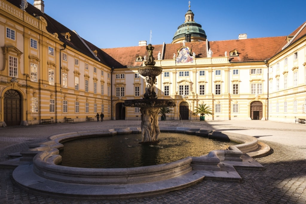Fountain in the courtyard of Melk Abbey, Austria with Baroque architecture