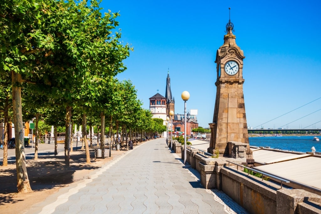 Düsseldorf Altstadt riverfront walkway with trees and historical landmarks