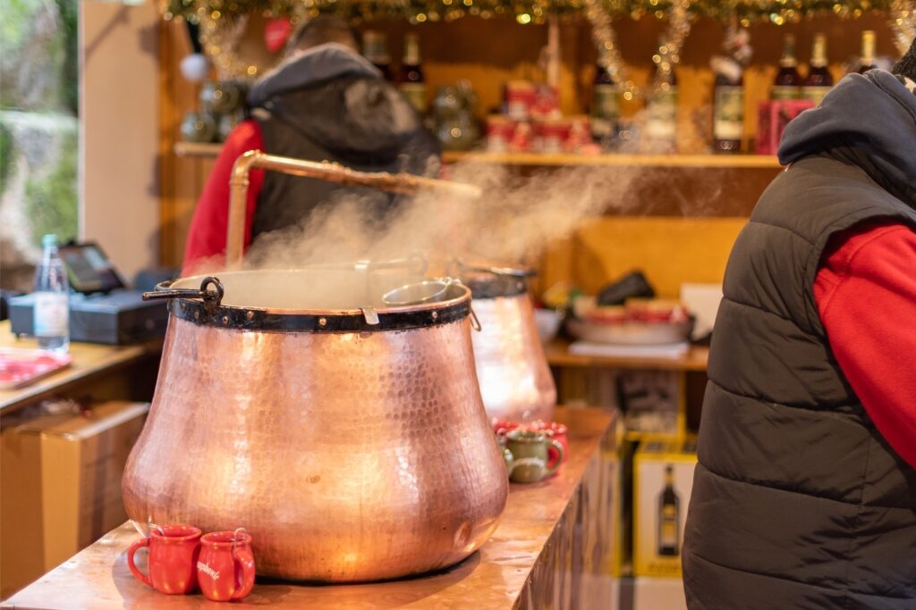 Glühwein being prepared in a large pot at a Christmas market