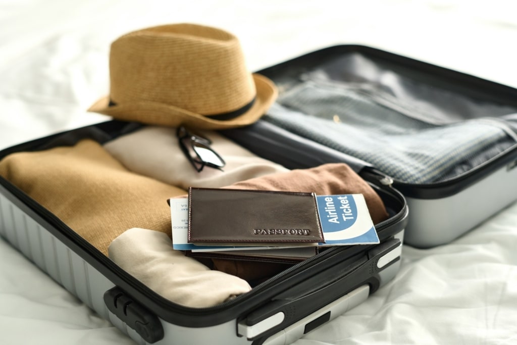 Suitcase with clothes and passport