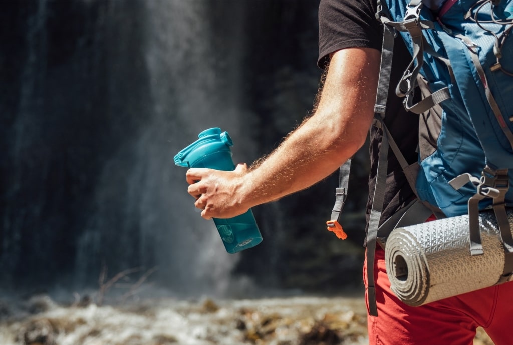 Man holding refillable water bottle