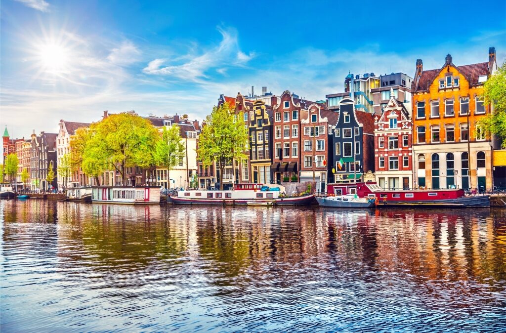 View of Amstel River lined with colorful buildings in the De Pijp neighborhood