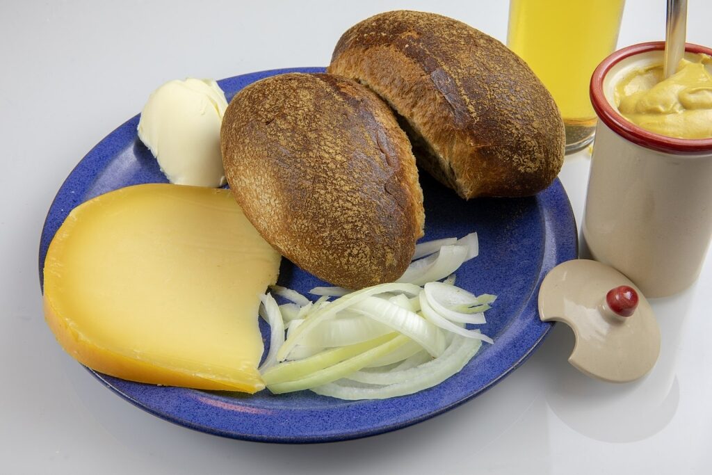 Halver Hahn rye bread roll with Gouda cheese, mustard, and pickles