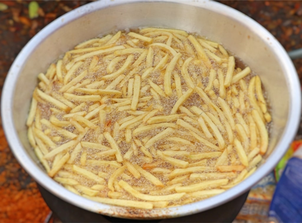 Traditional Amsterdam fries frying in pan