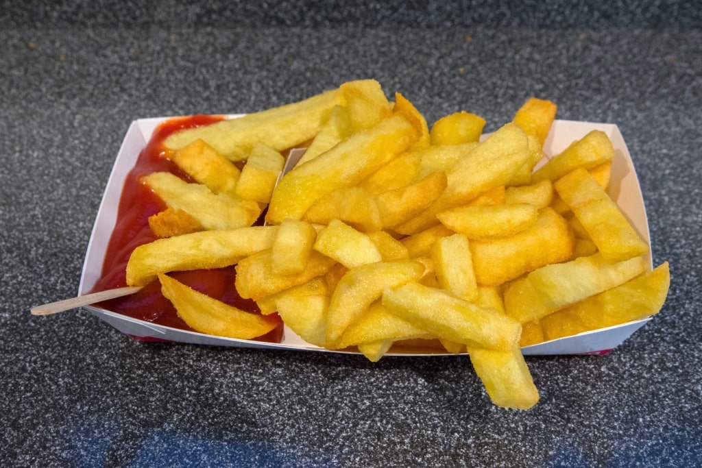 Freshly served golden fries with ketchup
