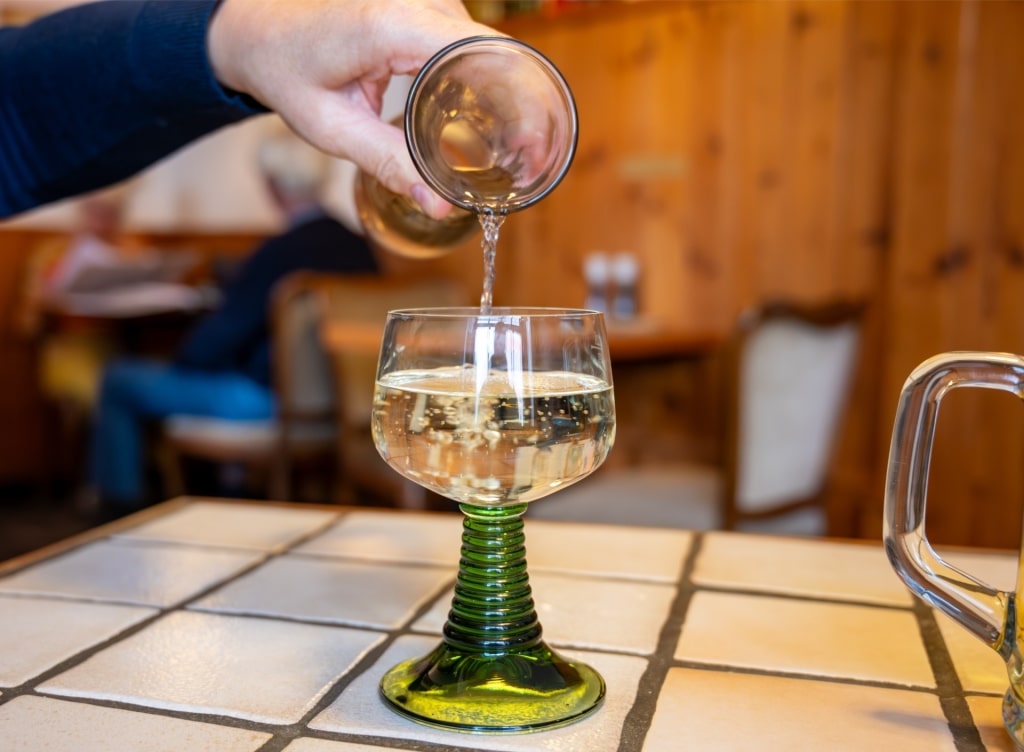 Pouring Riesling white wine into glass