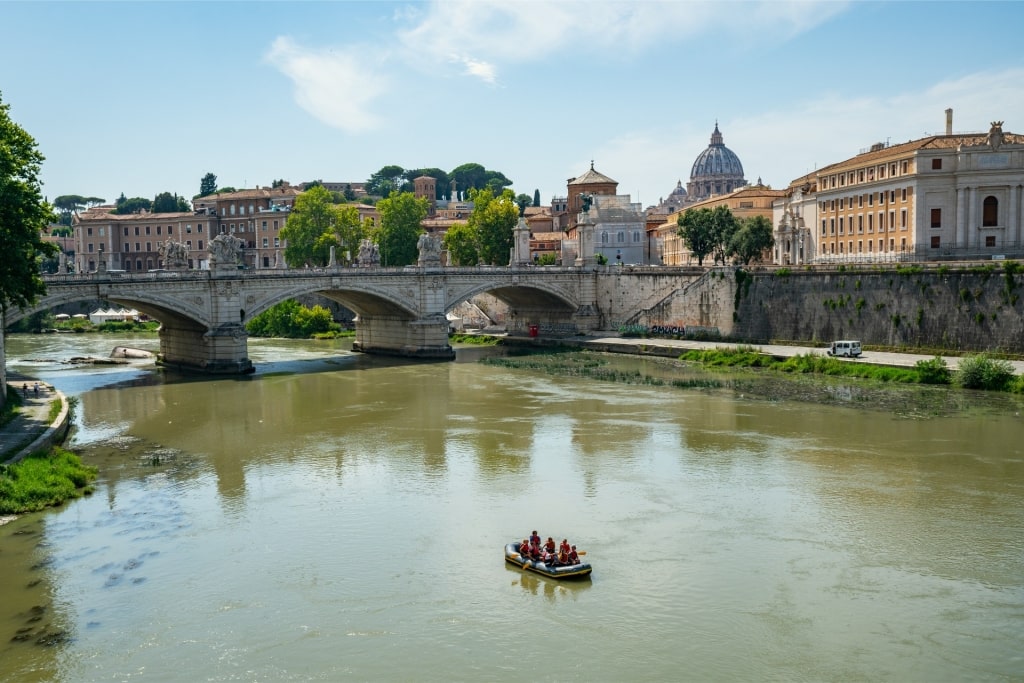 People on a rafting tour along Tiber River in Rome, Italy