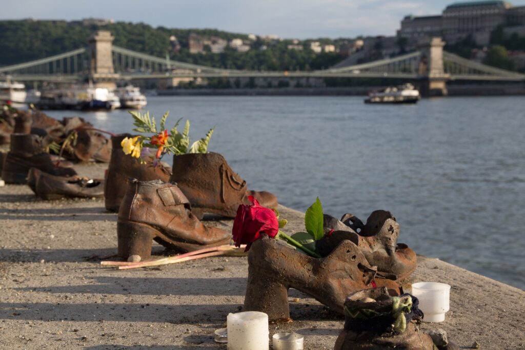 Shoes on the Danube Bank Memorial with view of the bridge