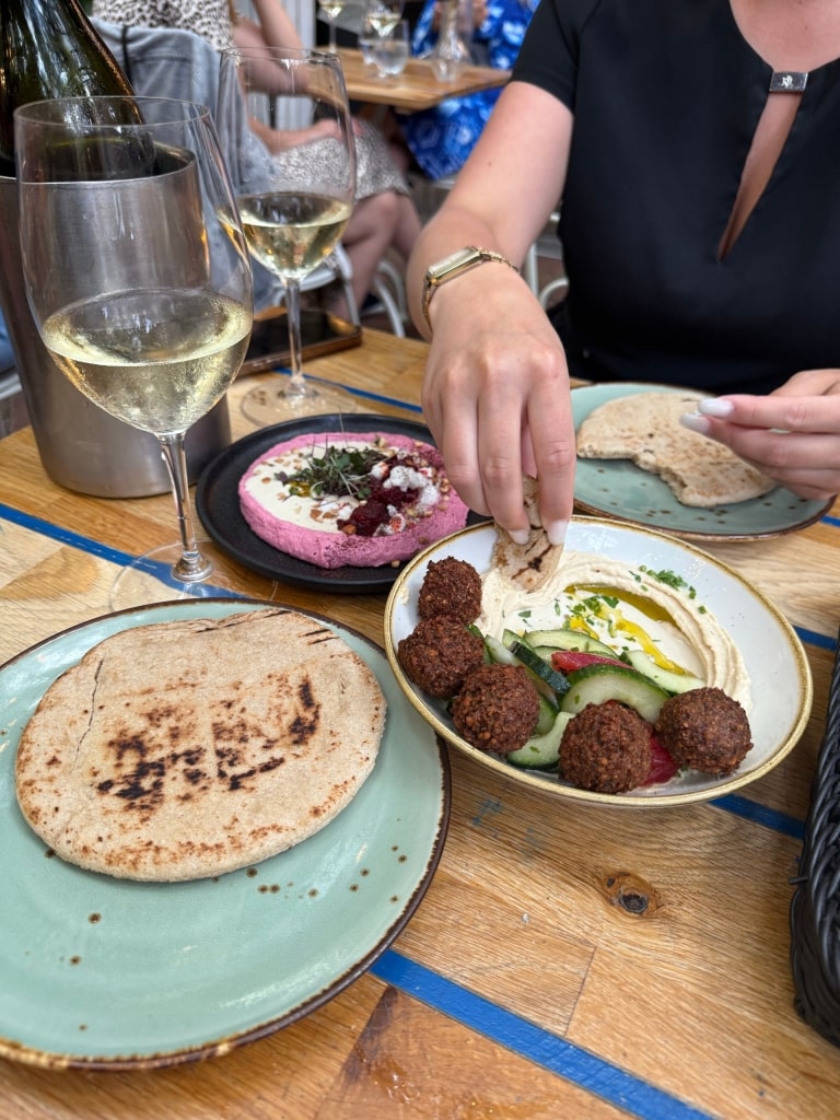 People dining at Mazel Tov restaurant