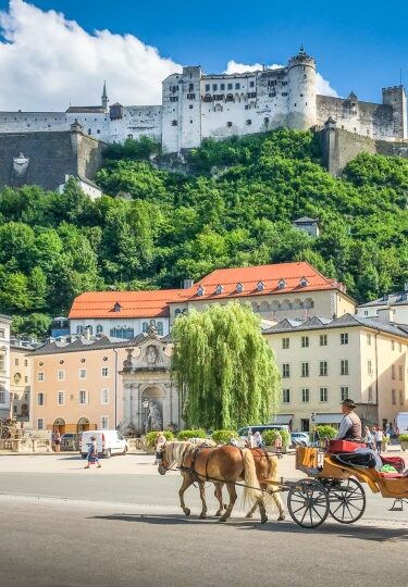 Scenic view of Hohensalzburg Fortress with horse-drawn carriage in Salzburg