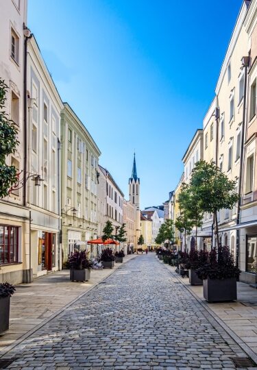 Historic Passau Old Town street lined with colorful storefronts