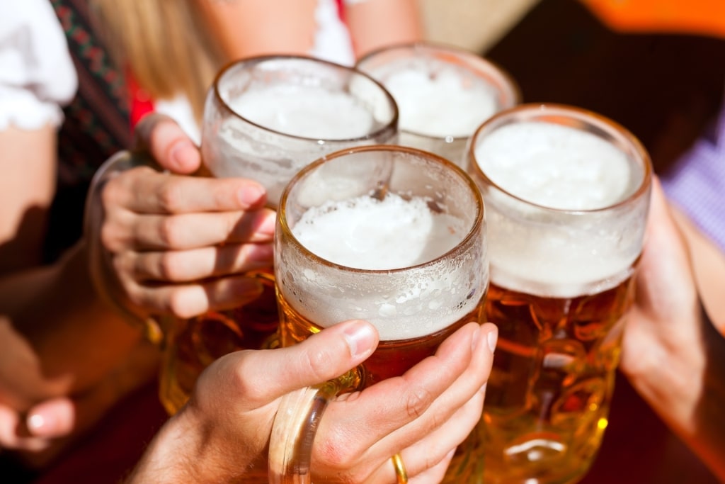 Close-up of clinking beer glasses during a German toast