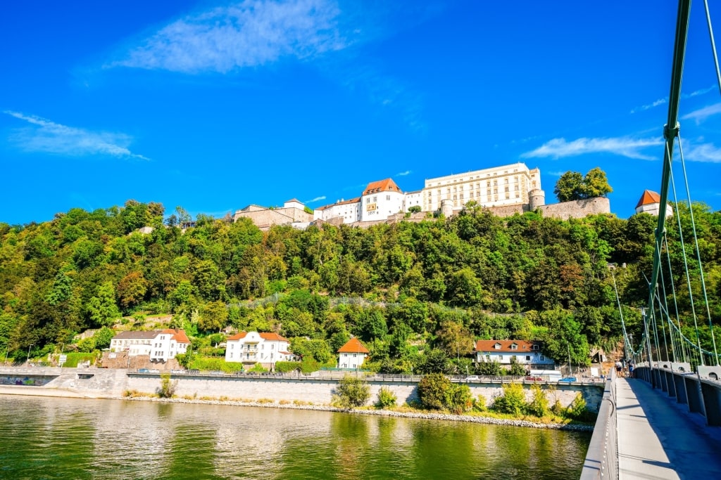 View of Veste Oberhaus castle on the hill above the Danube from a bridge in Passau