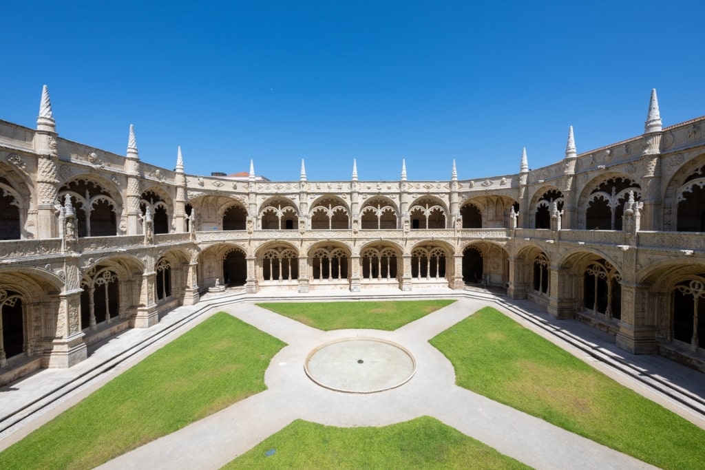 Jerónimos Monastery cloister garden surrounded by carved stone arcades in Lisbon
