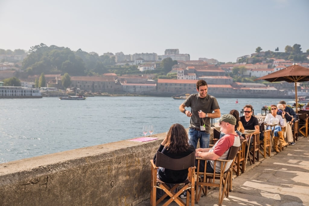 Open-air café with outdoor seating along the River Douro in Porto