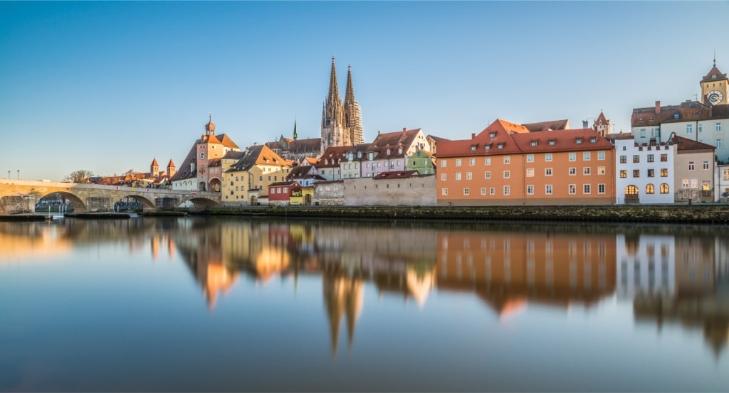 Scenic view of Regensburg cityscape along the Danube River with cathedral