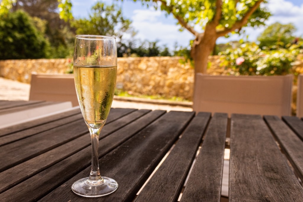 A glass of cava on a brown table