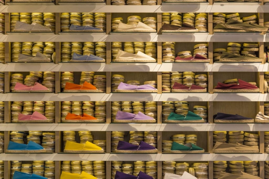 Colorful espadrilles neatly displayed on shelf as souvenirs from Barcelona