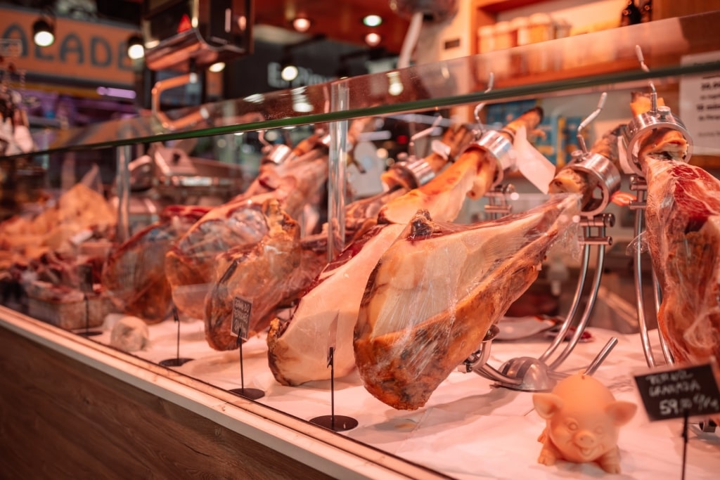 Food stall selling jamón ibérico at Boqueria market in Barcelona