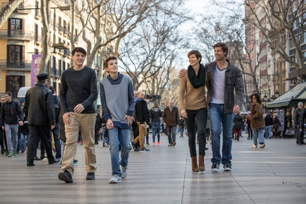 Tourists enjoying a walk along Barcelona’s iconic La Rambla