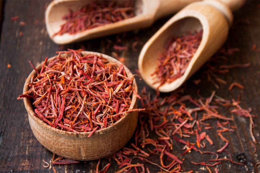 Bright red Spanish saffron threads in wooden bowl