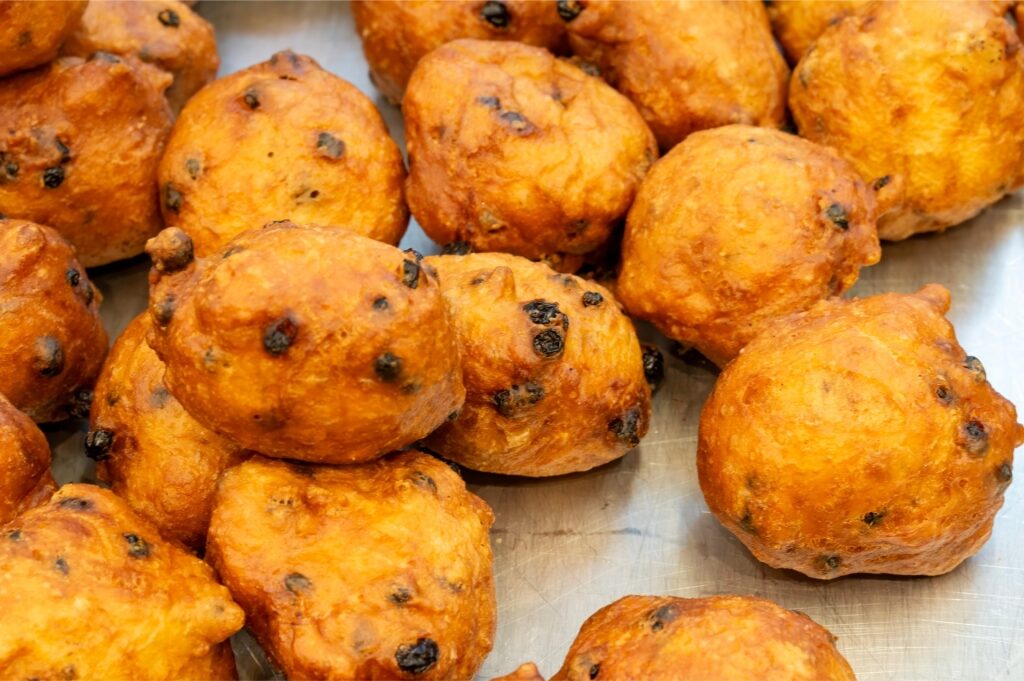 Close-up of golden oliebollen dough balls at market