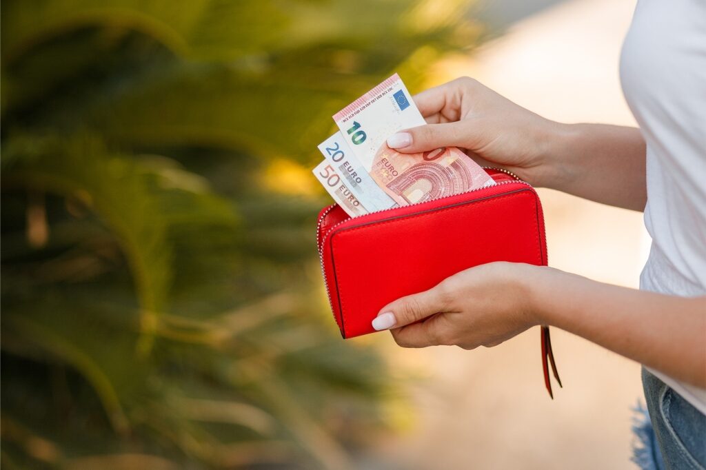 Woman holding a purse with euros