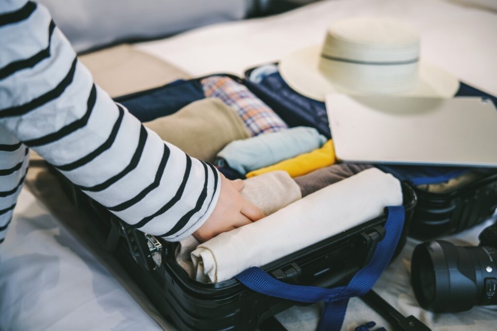 Woman packing clothes in a luggage