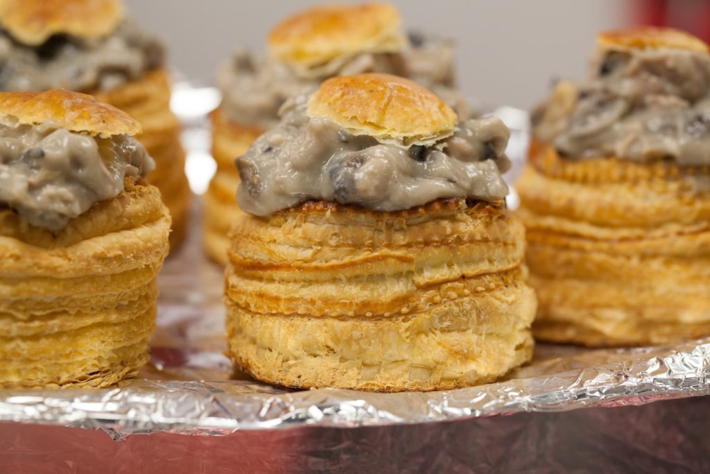Golden puff pastry vol-au-vent filled with mushroom, classic Bouchée à la Reine dish