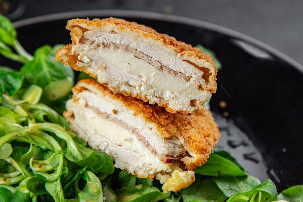 Close-up view of golden fried Cordon Bleu with cheese inside