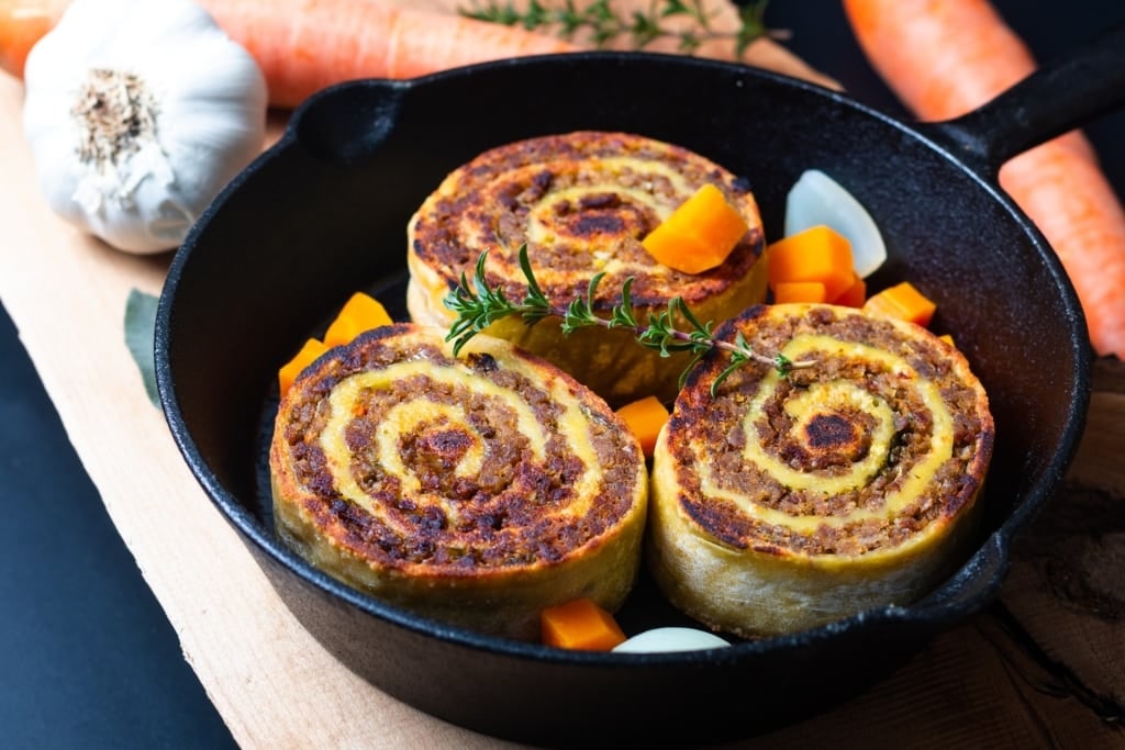Plate of Fleischschnacka, traditional spiral-shaped meat and noodle dish from Alsace