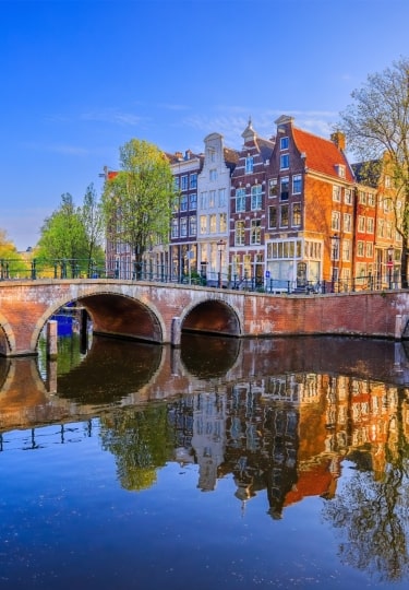 Keizersgracht, one of Amsterdam canals with arched bridges and reflections