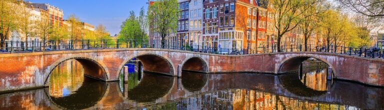 Keizersgracht, one of Amsterdam canals with arched bridges and reflections
