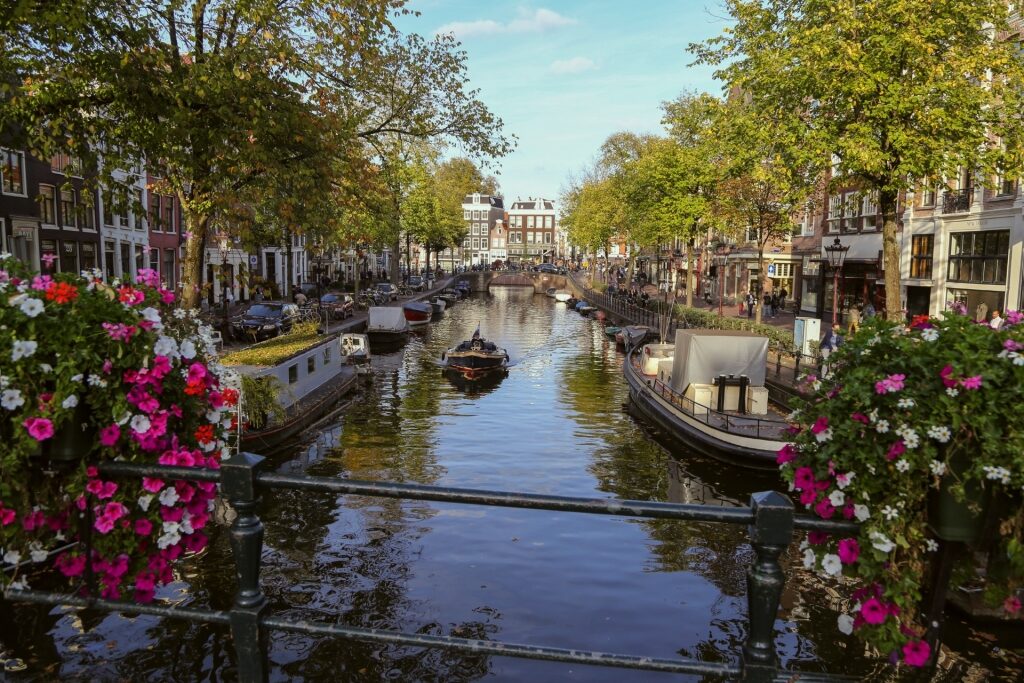 Scenic view of Spiegelgracht canal in Amsterdam with boats and trees