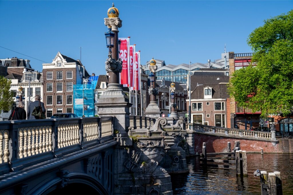 Iconic Amsterdam bridge Blauwbrug with lamps and decorative details