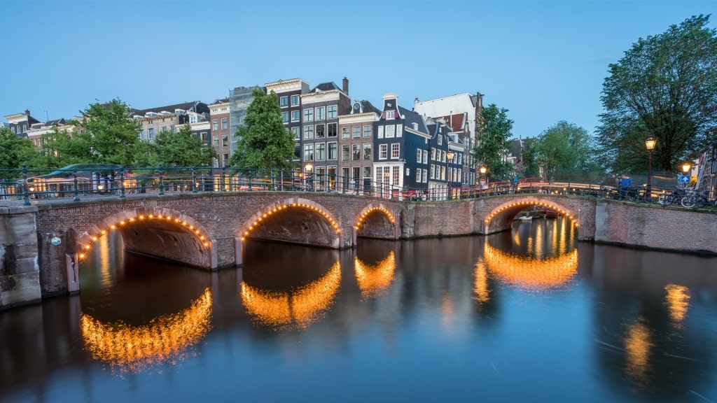 Picturesque Reguliersgracht waterway showcasing illuminated bridges