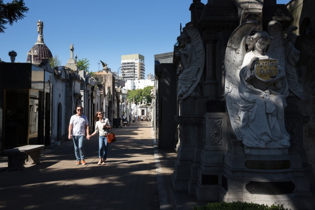 Couple wandering among mausoleums at Recoleta Cemetery, Buenos Aires