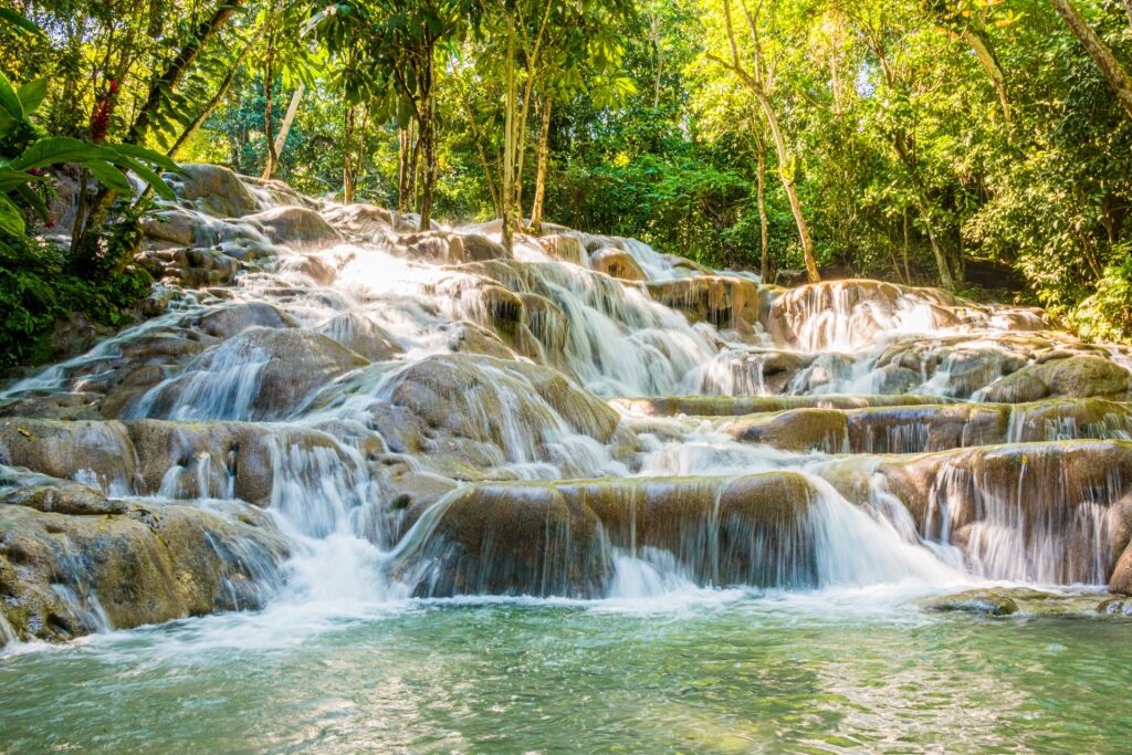 Cascading waterfalls surrounded by tropical greenery at Dunn’s River Falls, Jamaica