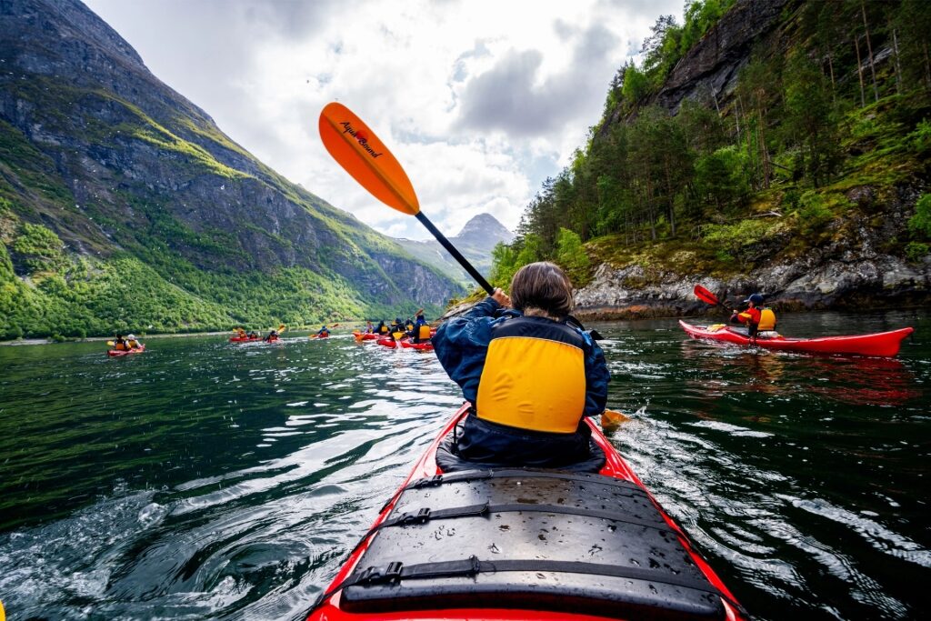 Adventure kayaking in Norway’s Geirangerfjord with fjord landscape